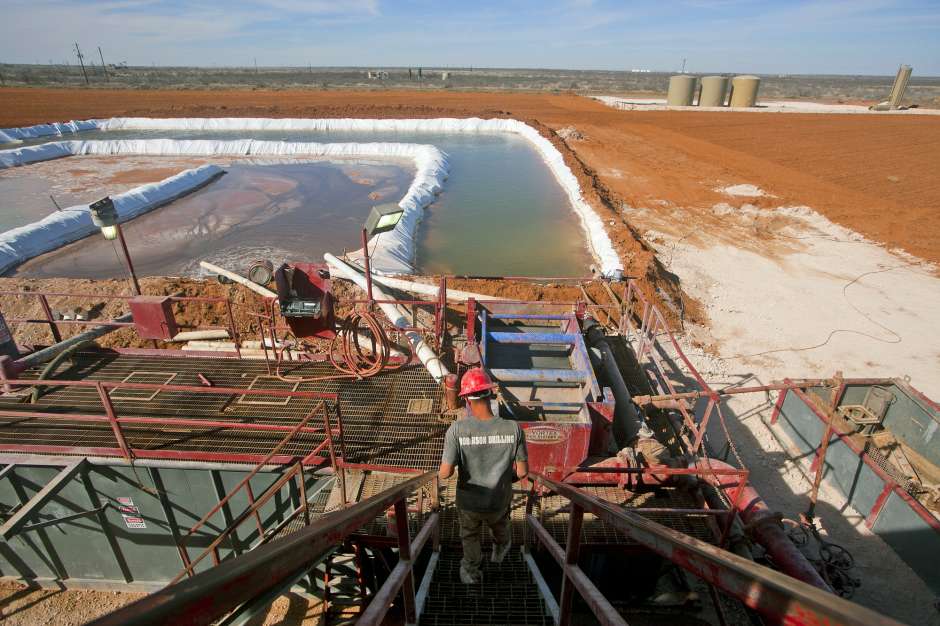 huston_chronicle_2_24 A rig worker descends the stairs toward the water pool attached to Robinson Drilling Rig No. 44.<br>
Photo: James Durbin/Midland Reporter-Telegram
